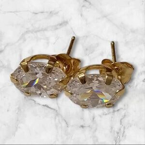 14K yellow gold stud earrings, featuring 7x5mm oval cubic zirconia stones